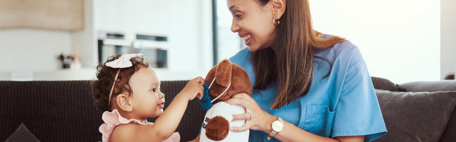 a healthcare provider playing with a toddler