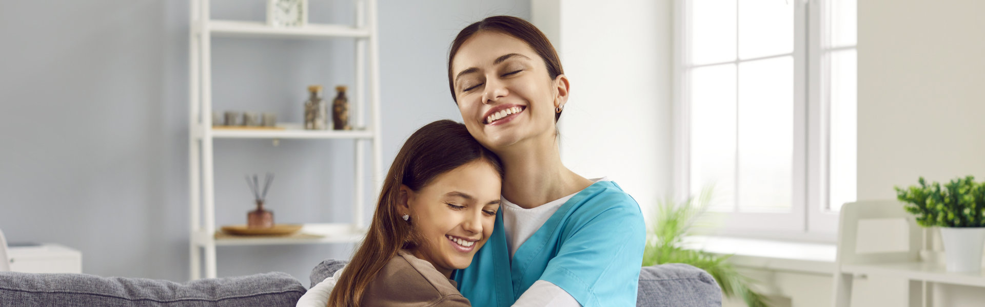 a healthcare provider hugging a child